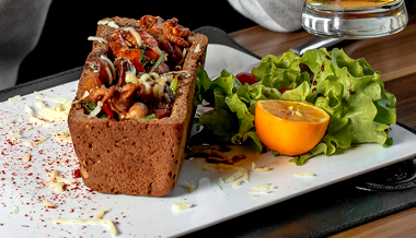 Stuffed bread bowl with side salad